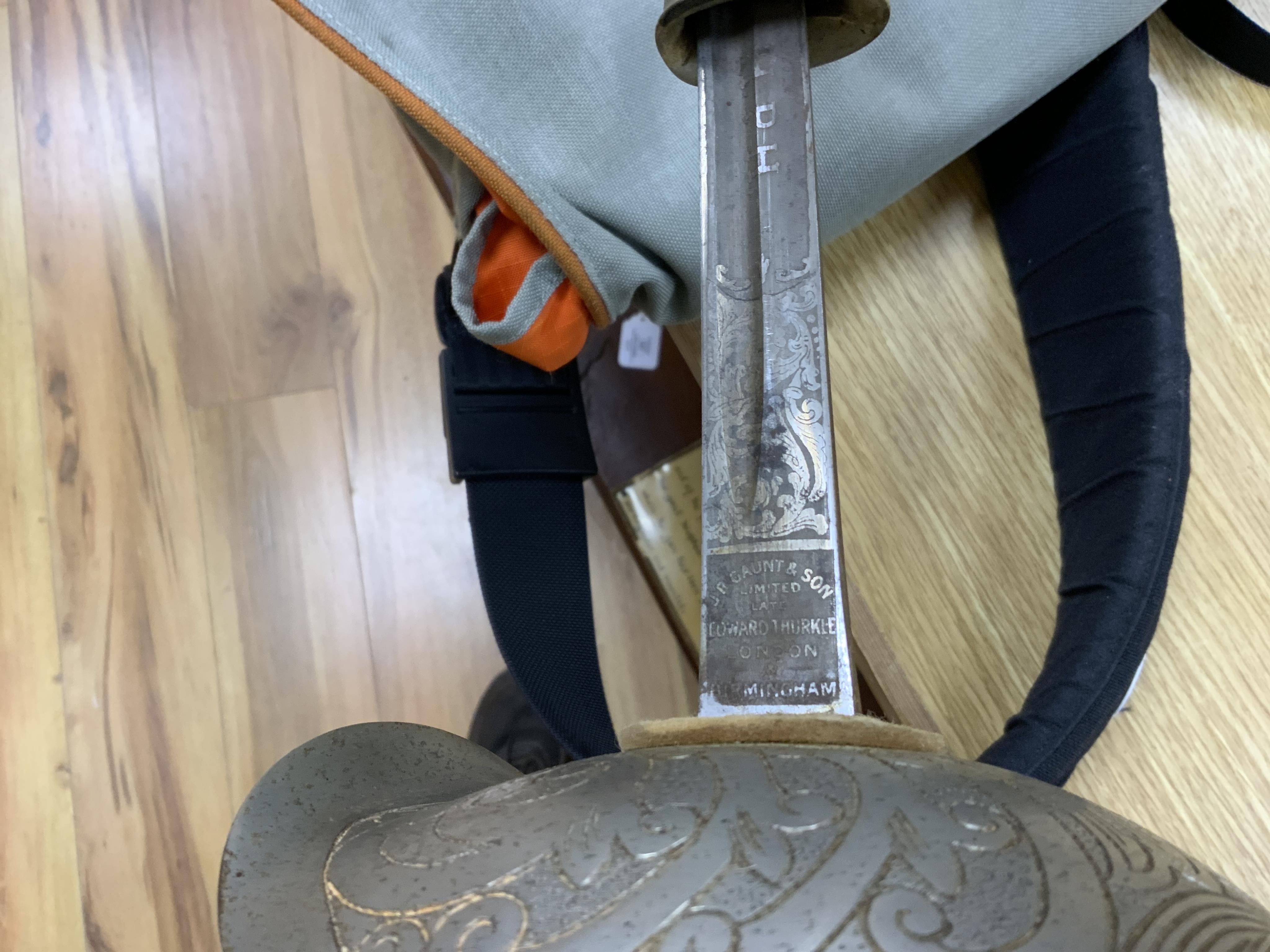 A 1911 pattern cavalry officer’s sword by J. Gaunt and son, etched with crowned GVR cipher and owner’s initials; HPH, regulation hilt and leather covered scabbard